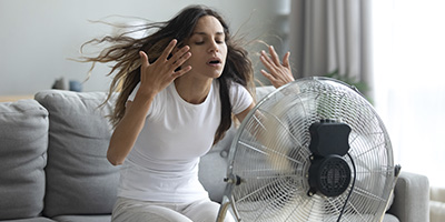 Woman in front of a ventilation fan