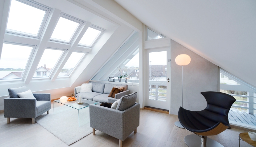 Attic converted into a modern living room with six VELUX roof windows.