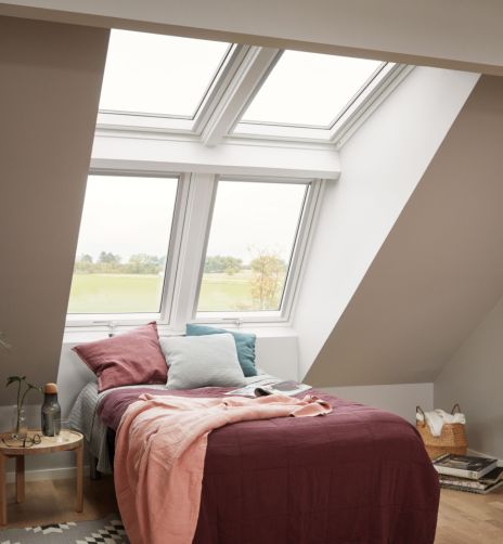 Bright bedroom with four big VELUX roof windows.