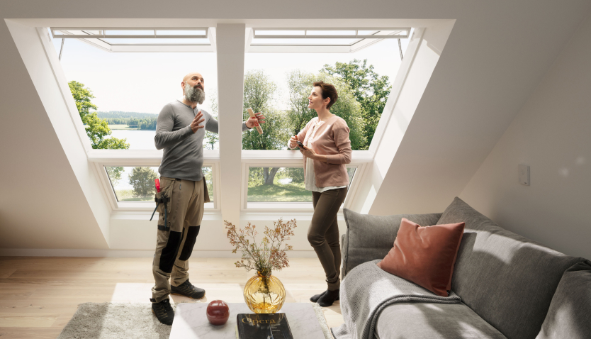 Installer explaining the process of installing VELUX roof windows to a customer that just got two new VELUX roof windows.