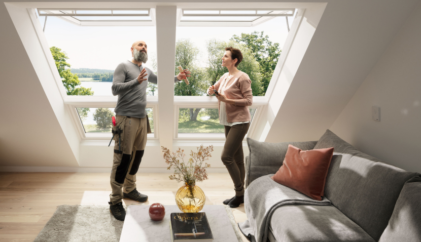 Installer explaining the process of installing VELUX roof windows to a customer that just got two new VELUX roof windows.