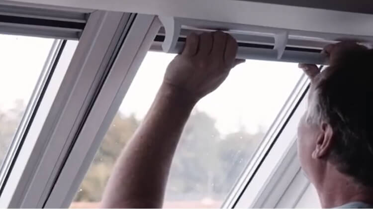 Thumbnal picture of a man operating roof window