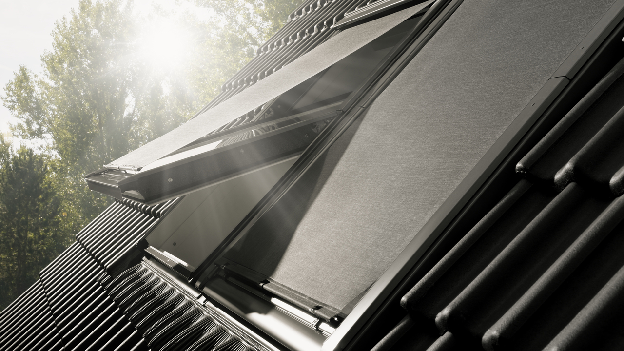 Image of tiled roof with VELUX roof window and awning blinds installed