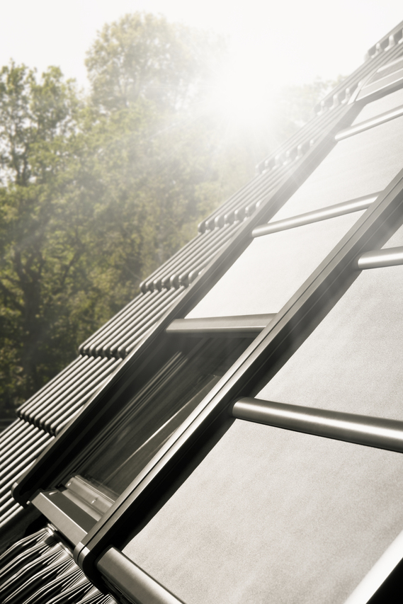 Image of sun hitting VELUX roof windows with soft shutters installed