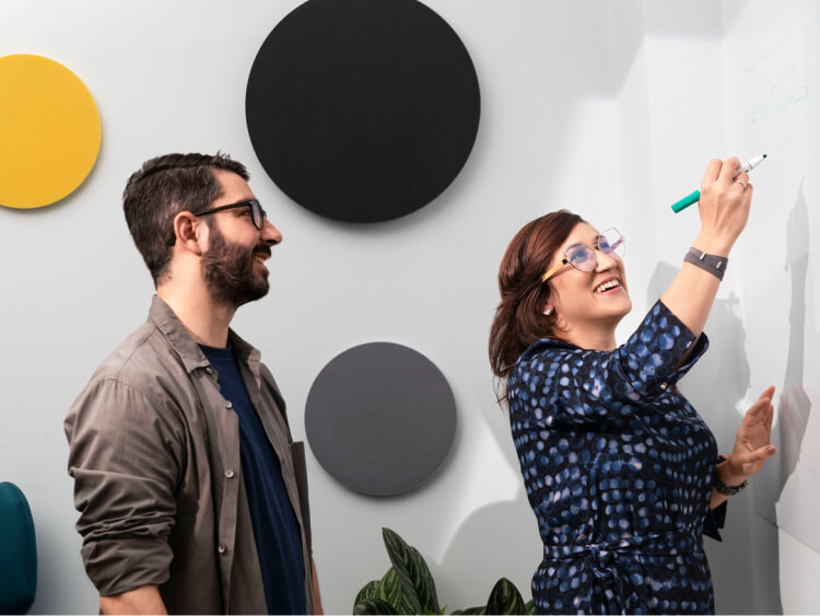Two people by the white board
