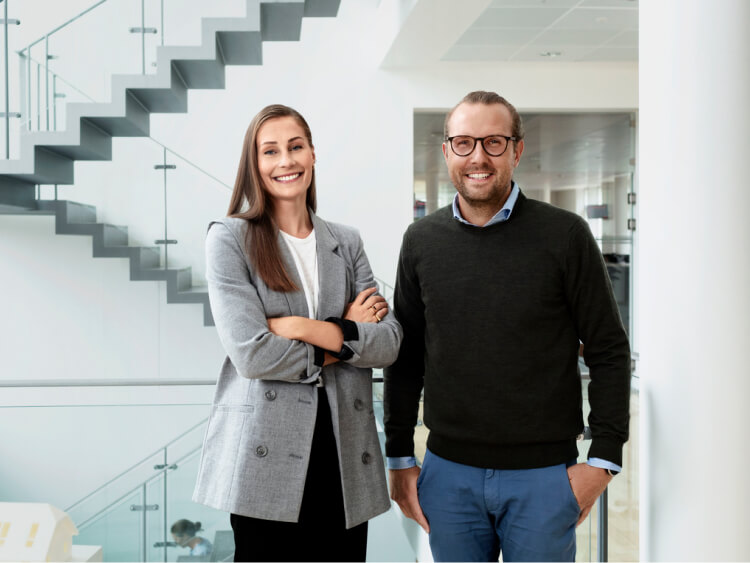Two people standing in a hall