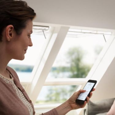 Woman checking VELUX  Smart Home app