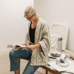 Image of a woman reading a VELUX catalogue