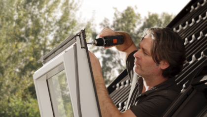 Installer mounting a window