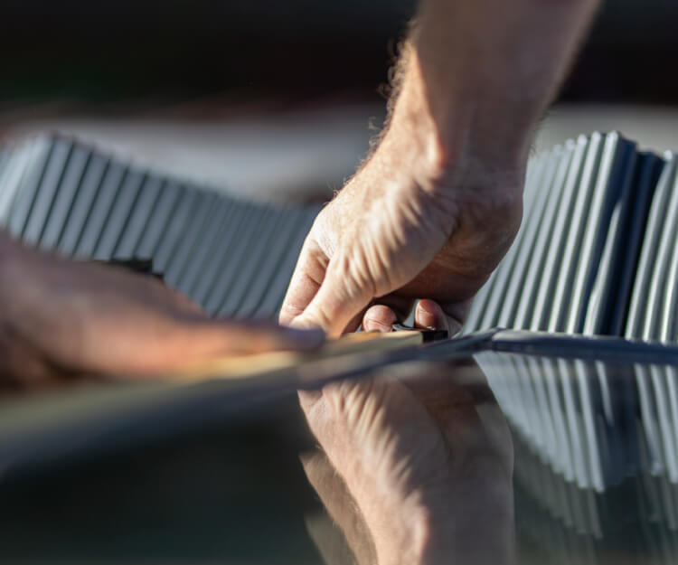 close-up of installer's hands working on a VELUX window