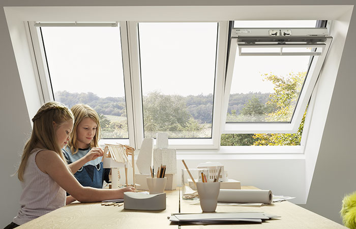 Children beside a table and combo windows in the background
