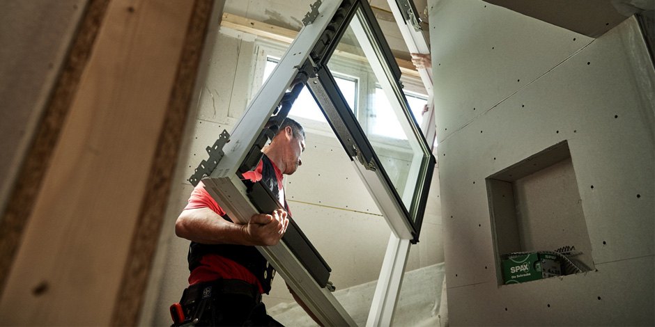 Installers installing roof windows
