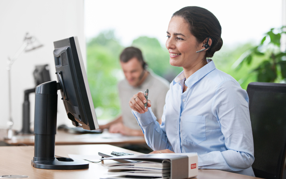 Woman and man at VELUX call center helping customers with after sales support.