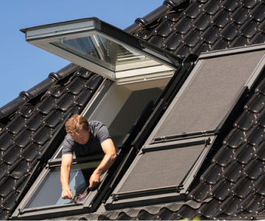 Installer installing a VELUX roof window in a tiled roof